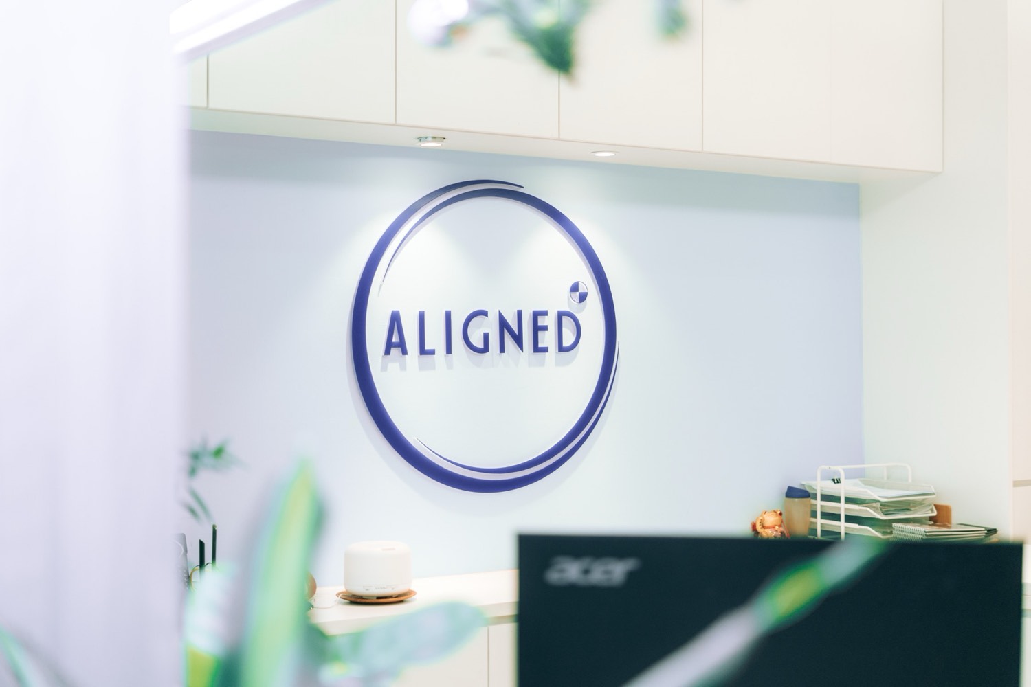 The Aligned logo wall behind the reception counter